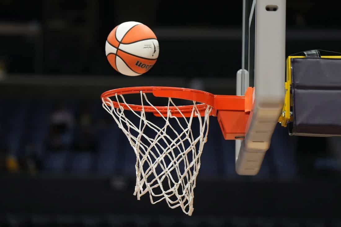 A basketball entering a hoop