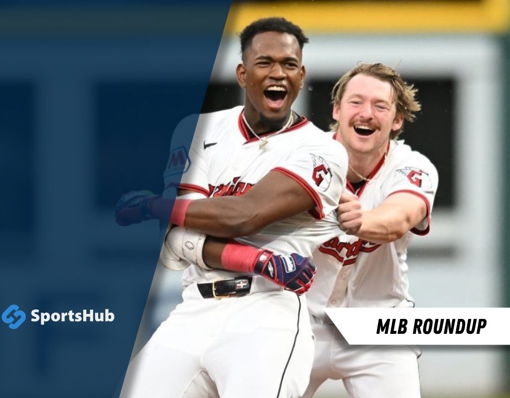 Two baseball players celebrate a thrilling moment on the field, wearing white and red uniforms, with a sports logo in the corner.
