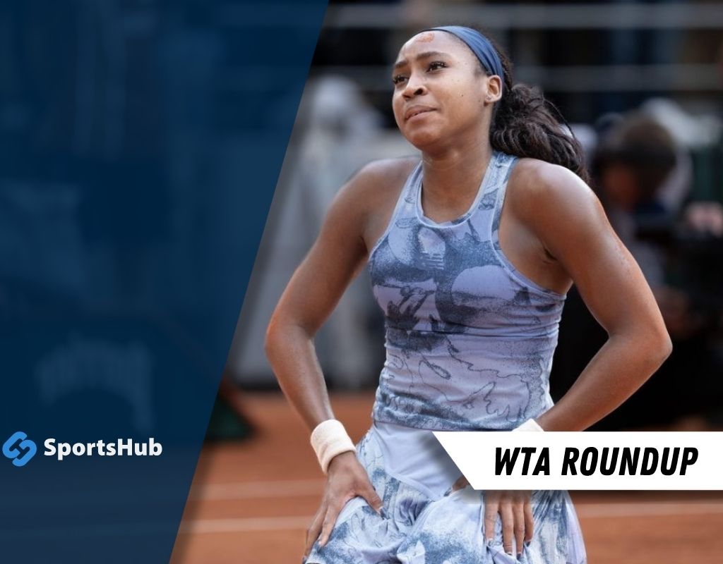 A tennis player in a patterned outfit stands on the court, displaying determination during a WTA match. SportsHub logo in corner.